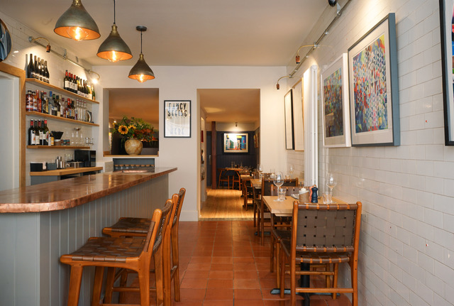 Fino in Cromer, Norfolk — stylish, intimate restaurant interior with copper bar, pendant lighting, modern artwork and terracotta tiled floor — Central & East of England regional winner, Best Local Restaurant 2025 in The Good Food Guide.