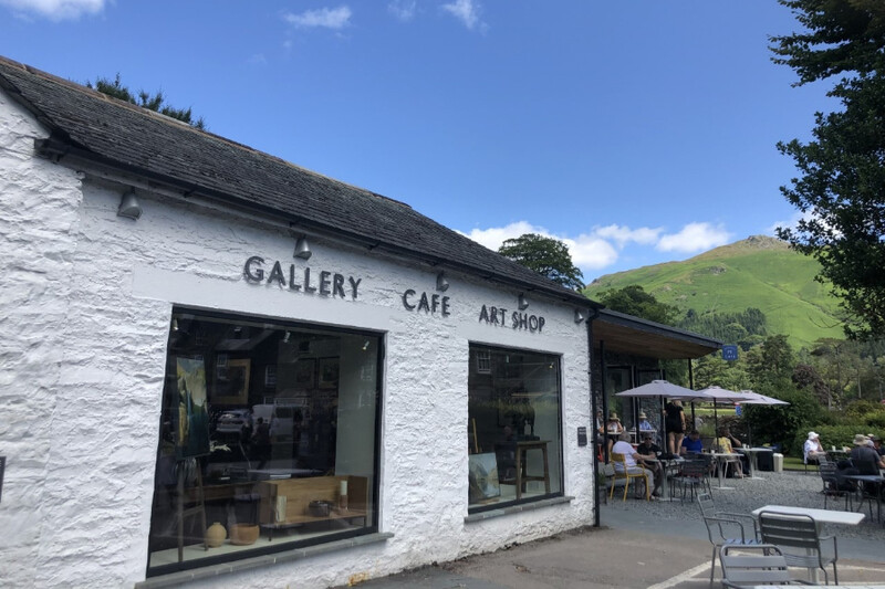 Whitewashed gallery and café building with outdoor seating at Mathilde’s Café, Grasmere