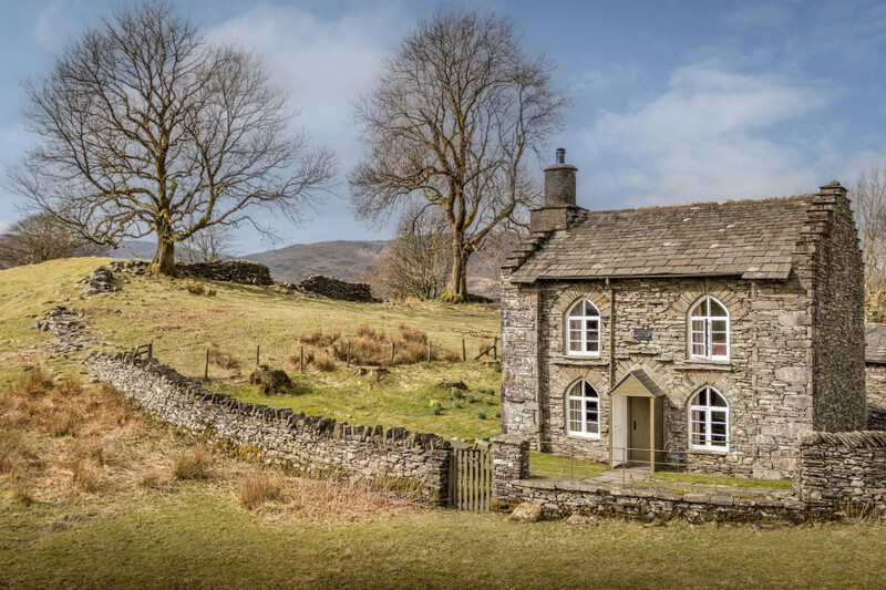 Stone cottage beside a dry-stone wall at Rose Castle Cottage, Coniston